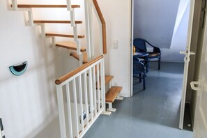 A staircase with wooden steps and white railings leading to a landing. - Holiday apartment with 2 bedrooms (Born a. Darß)
