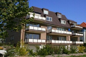 A multi-story residential building with balconies and large windows. - Holiday apartment with 2 bedrooms (Ostseebad Boltenhagen)