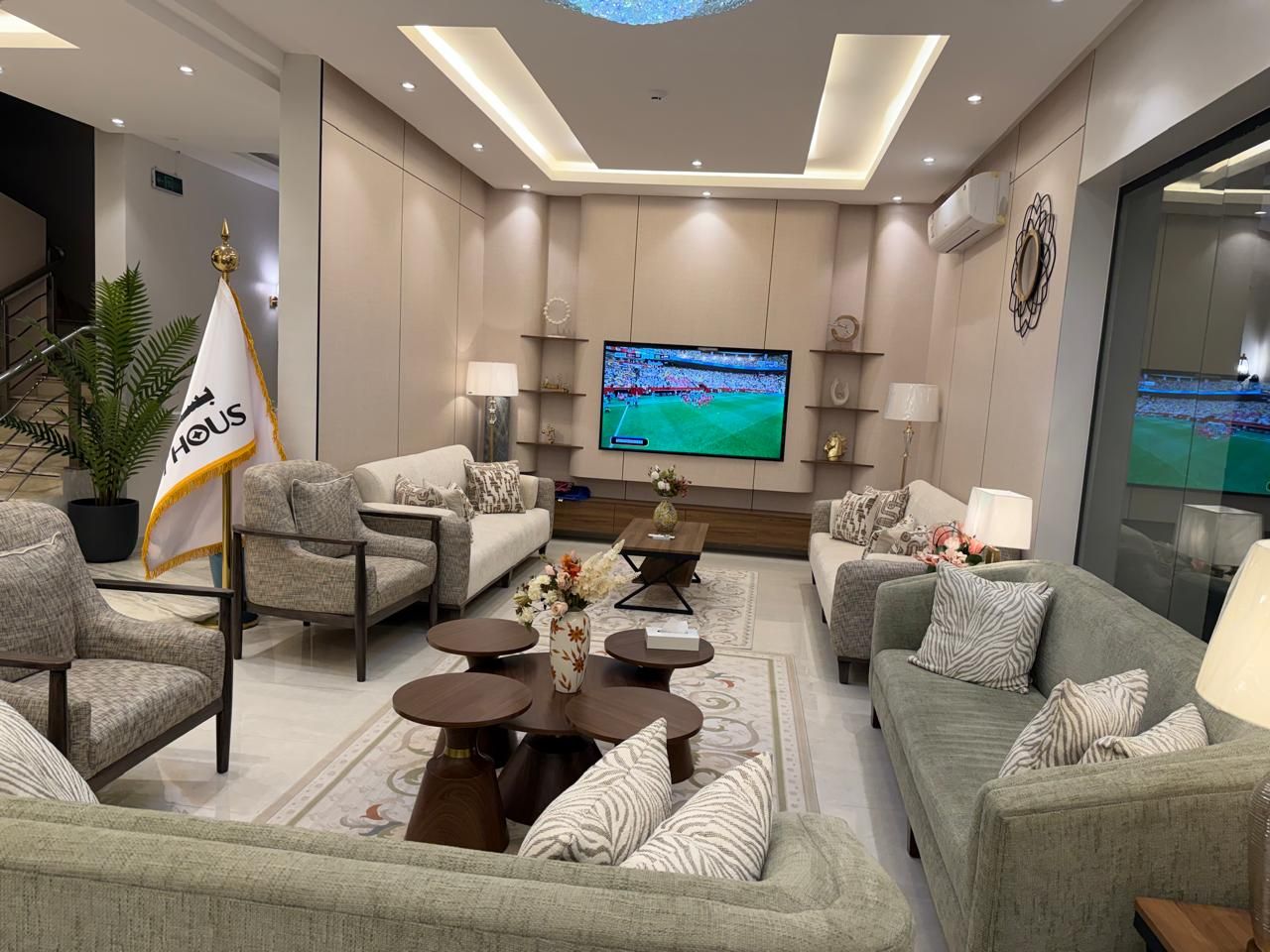 A modern living room with sofas, a coffee table, and a television.