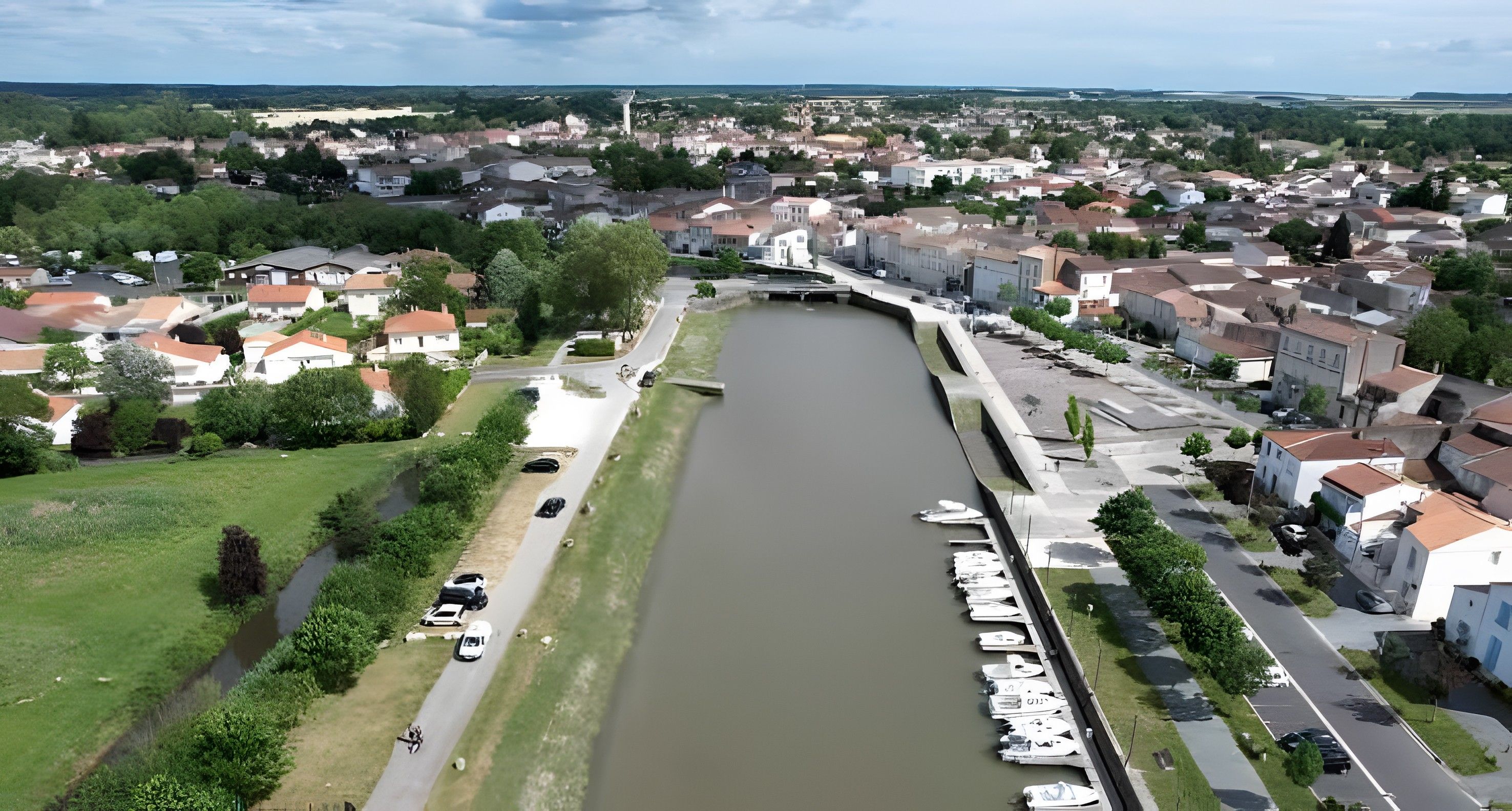 A river running through a town with houses on both sides.