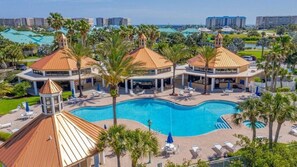 A resort with a central swimming pool, lounge areas, and multiple buildings with similar architecture. - 2206 Harbour Village (Ponce Inlet)