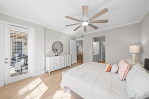 A bedroom with a bed, a dresser, a ceiling fan, and a window with blinds. - 2306 Harbour Village (Ponce Inlet)