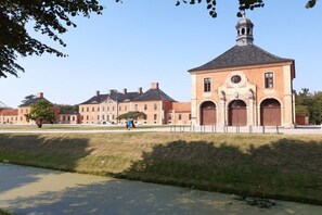 A historic building with a prominent clock tower, large arched windows, and a symmetrical facade. - Dike butterfly Boltenhagen (Ostseebad Boltenhagen)
