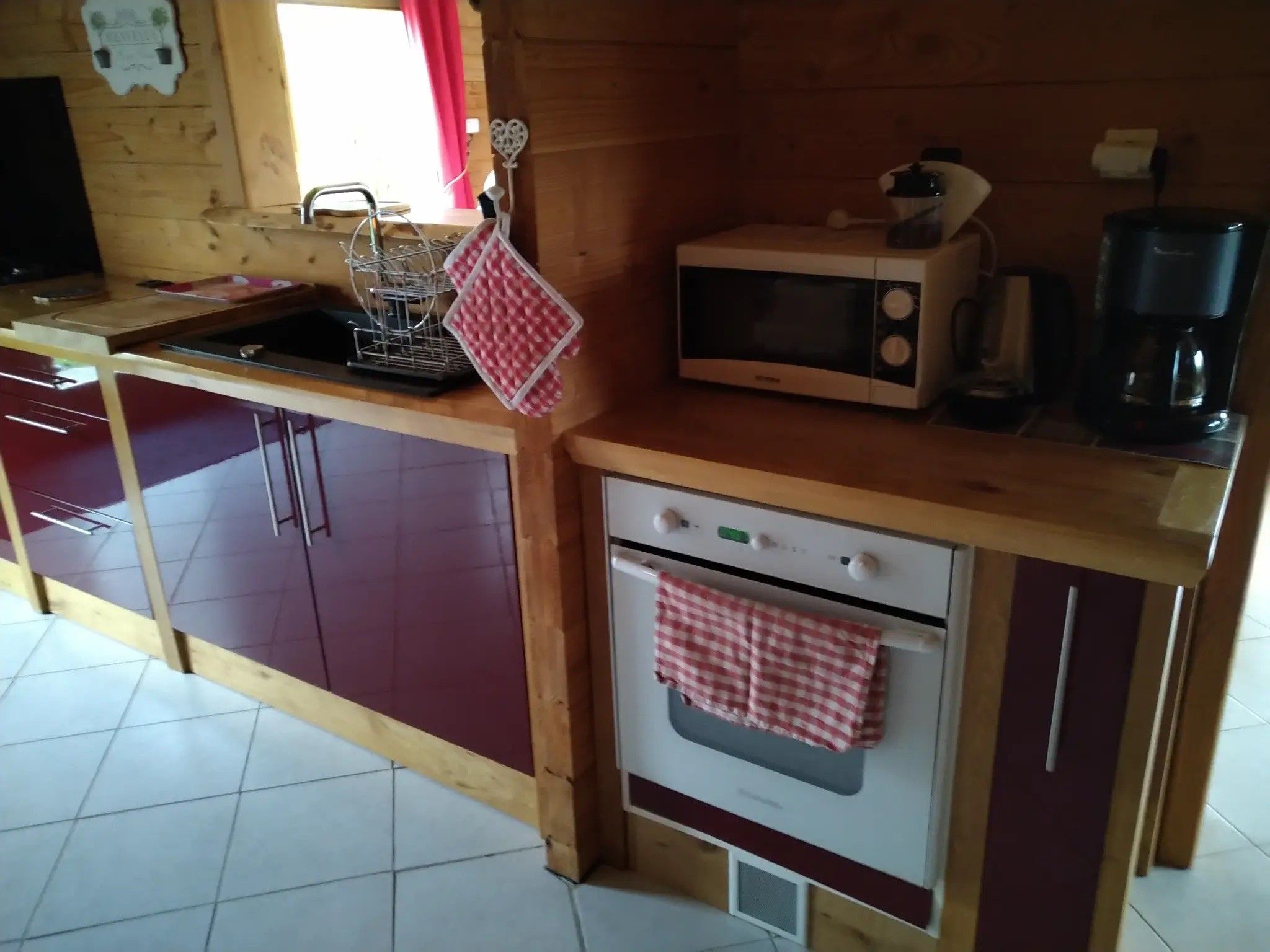 A compact kitchen with a microwave, coffee maker, and a small oven.