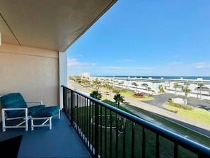 A balcony with a view of the ocean and a parking area. - #504 Tide Water Oceanview Condo (Ponce Inlet)