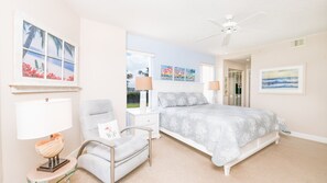 A bedroom with a bed, a chair, a nightstand, a lamp, and artwork on the walls. - #5111 Towers @ Ponce Inlet 2/2 Oceanfront Condo Traffic Free Beach (Ponce Inlet)