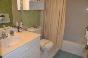 A bathroom with a sink, toilet, and bathtub. - #604 Sandcastle 2/2 Oceanfront condo - Traffic Free Beach (Ponce Inlet)
