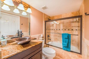 A bathroom with a glass-enclosed shower, a sink with a vessel basin, and a toilet. - 6103 Towers in Ponce Inlet, FL (Ponce Inlet)