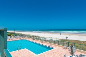 A swimming pool with a view of the beach and ocean. - 6103 Towers in Ponce Inlet, FL (Ponce Inlet)