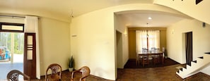 A room with a dining area, a staircase, and a view of the outdoors. - ELLA FOOD & BED (Ella)