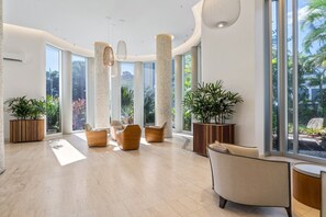 A spacious lobby with high ceilings, large windows, and modern furniture. - High-Rise 2-Bed Apartment in Surfers Paradise (Surfers Paradise)