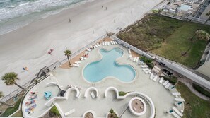 A resort with a large pool, sun loungers, and a beach area. - #806 Ashley 2/2 Oceanfront Condo Daytona Beach Shores (Daytona Beach Shores)