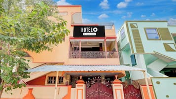 A two-story hotel with a sign reading 'HOTELO & Company-Serviced' above the entrance.