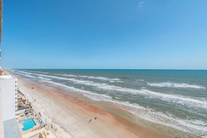 A beach with a pool and a view of the ocean. - Dimucci Twin Towers 1503 (Daytona Beach Shores)