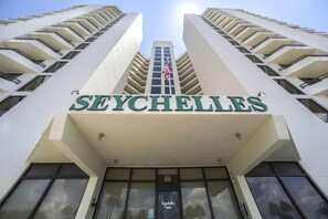 A building with the name 'SEYCHELLES' prominently displayed at the top. - #101 Seychelles 2/2 Oceanfront Traffic Free Beach (Daytona Beach Shores)