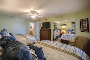 A hotel room with two beds, a television, a ceiling fan, and a mirror. - #304 Seychelles 3/3 Oceanfront Traffic Free Beach (Daytona Beach Shores)