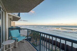 A balcony with a view of the ocean, a chair, and a small table. - Unit 402 at Towers 10 - Perfect Location with Great Oceanfront Views (Daytona Beach Shores)