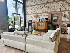 En moderne stue med sofasæt, sofabord og et skab med pynteting.