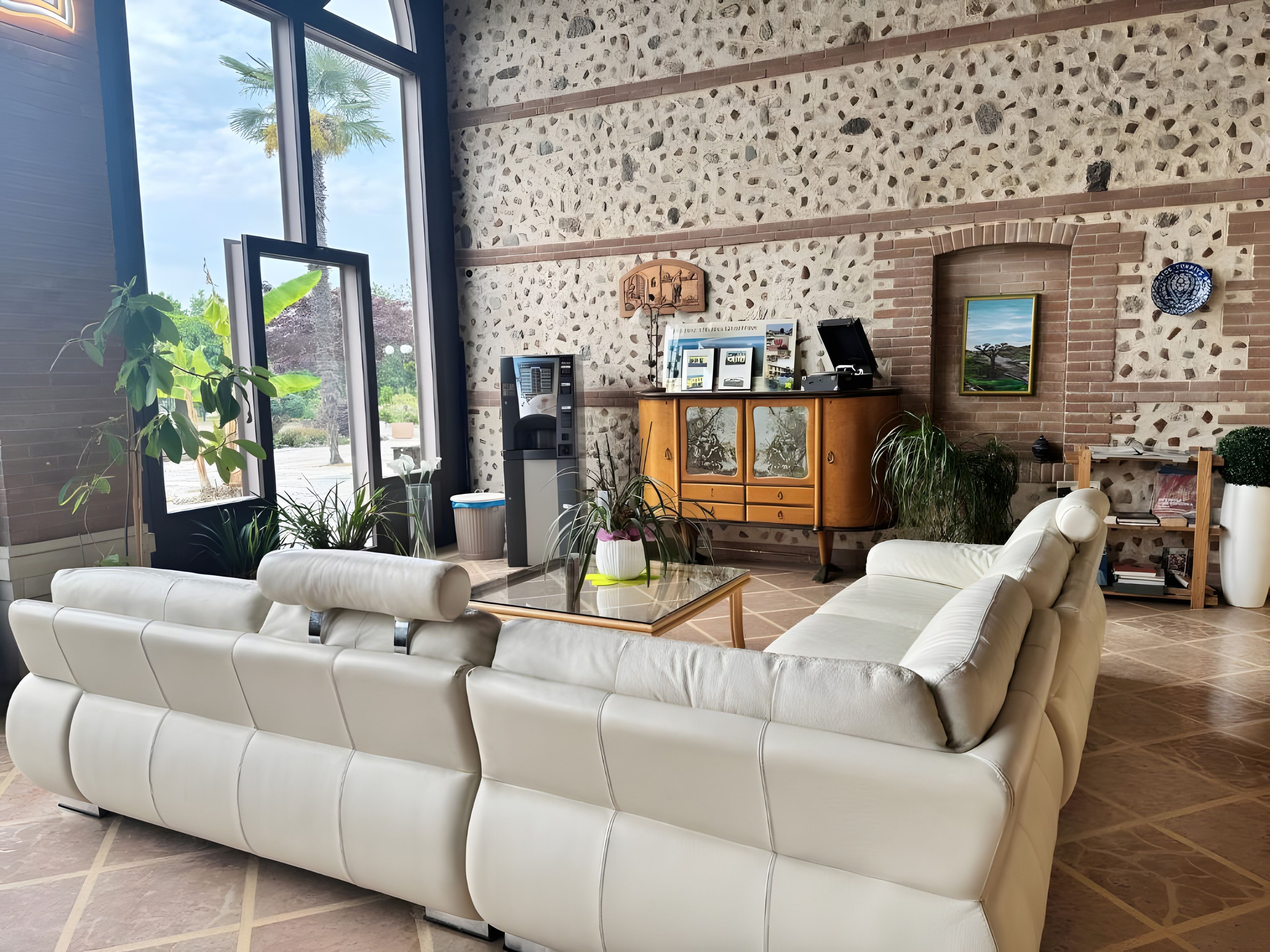 A modern living room with a sofa set, a coffee table, and a cabinet with decorative items.