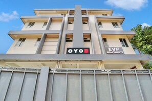A multi-story building with a modern architectural design, featuring a prominent vertical structure in the center. - Super Collection O Lefort LUXE (Thiruvananthapuram)