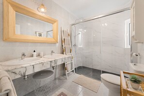 A modern bathroom with two sinks, a shower, and a toilet. - Paraiso Marino by Escape Home (Puerto del Carmen)