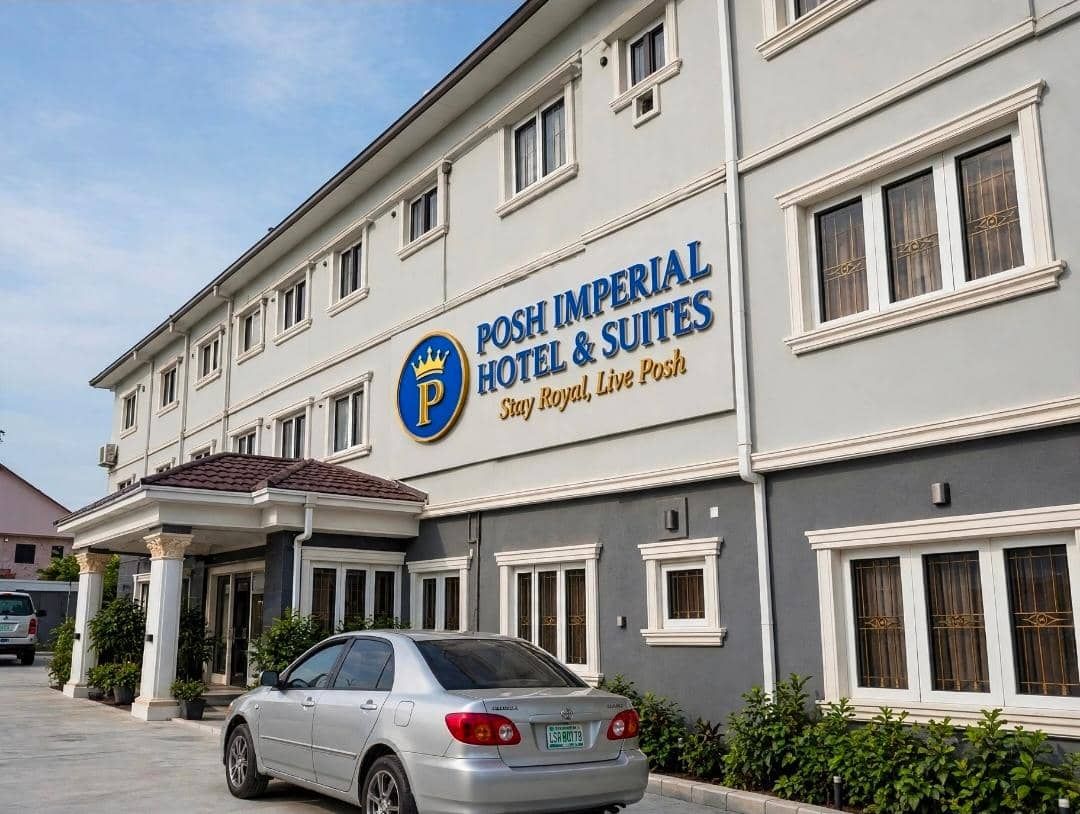 A hotel with a sign reading 'Posh Imperial Hotel & Suites Stay Royal, Live Posh'.