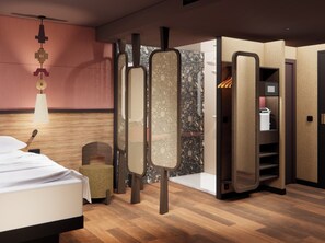 A modern hotel room with a bed, a small seating area, a wardrobe, and a bathroom. - Oceania Paris 17 (Paris)