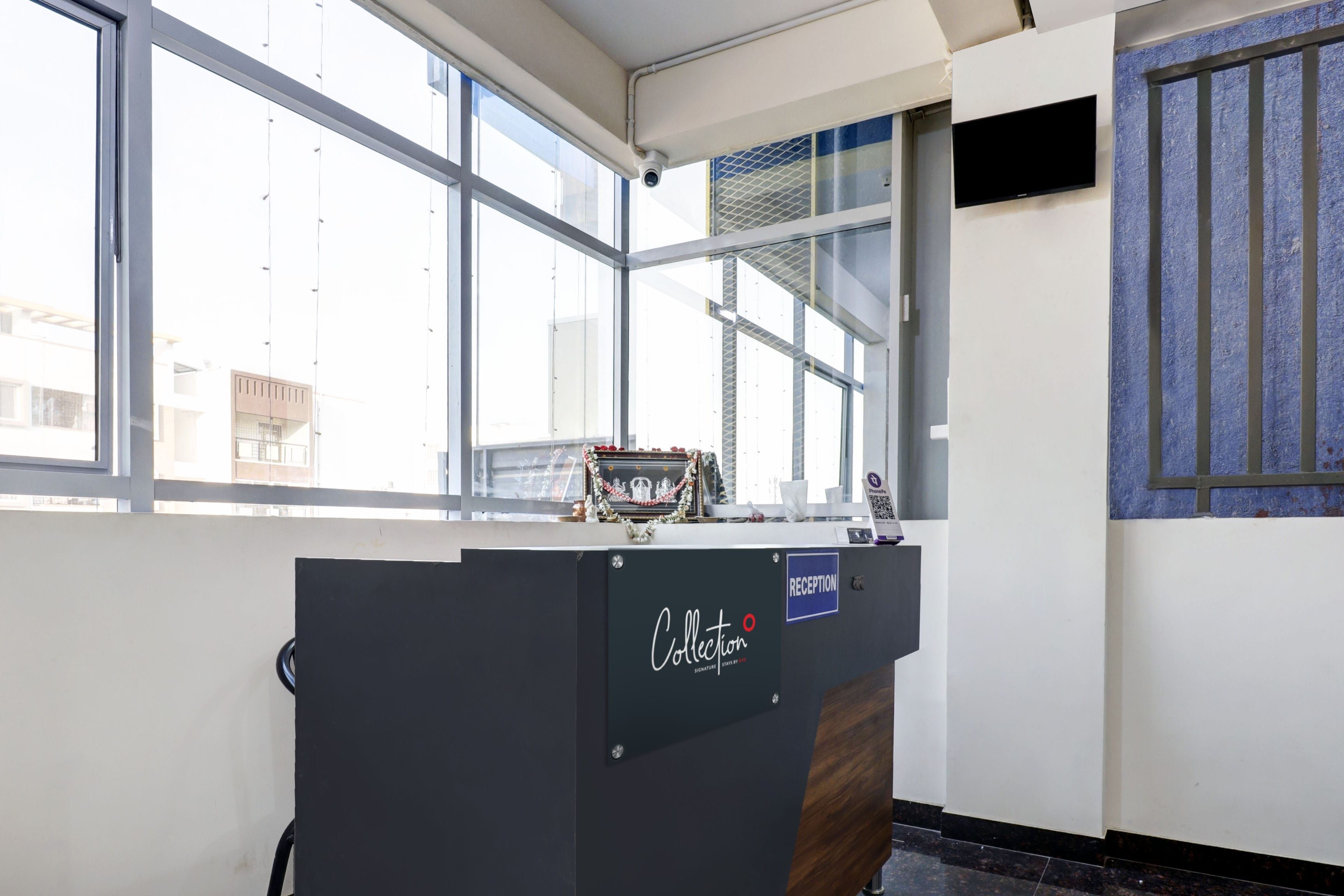 A reception desk with a sign that reads 'Collection' and a 'Reception' sign above it.