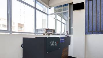 A reception desk with a sign that reads 'Collection' and a 'Reception' sign above it.
