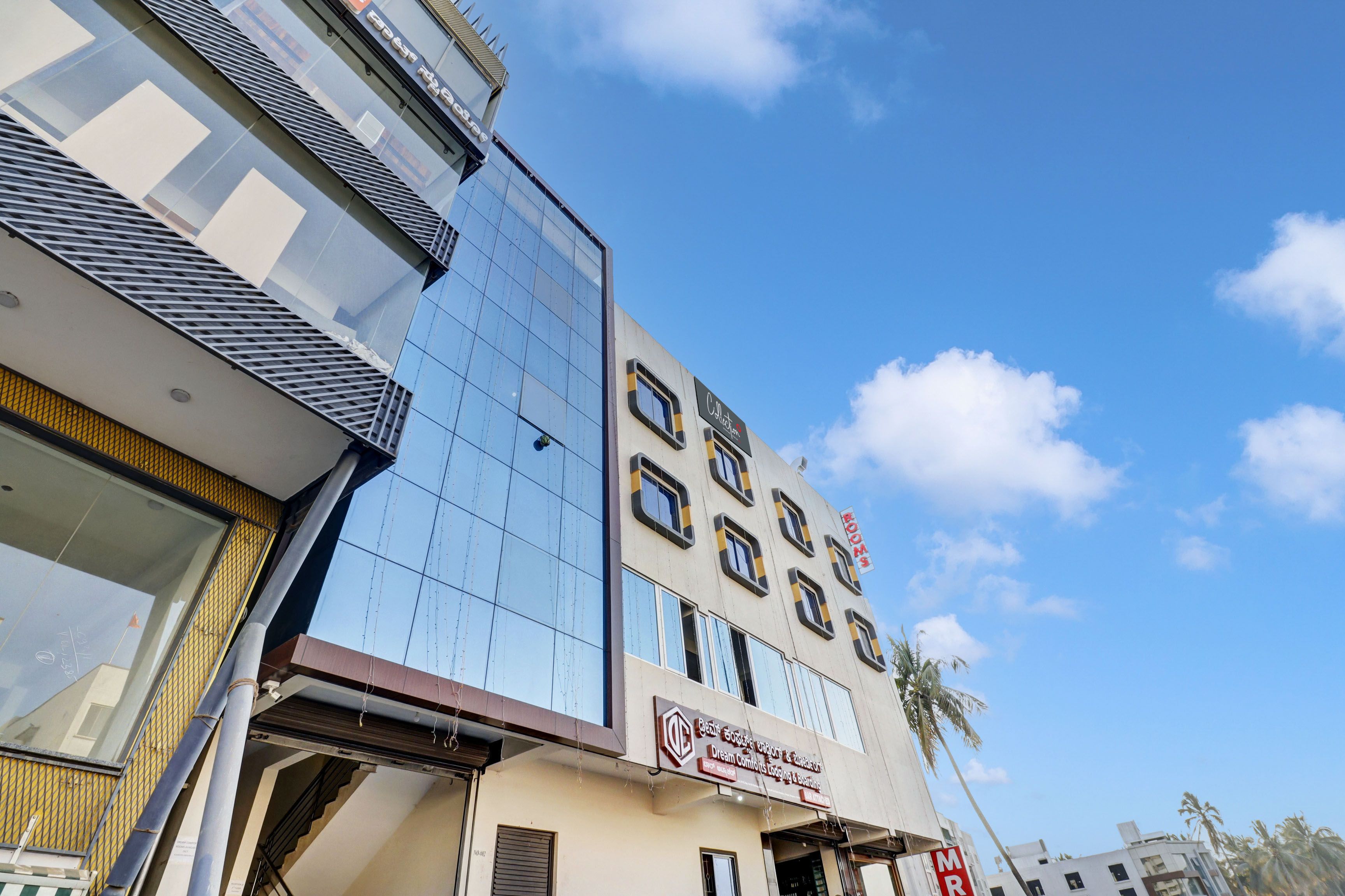 A multi-story building with a modern facade, featuring a mix of glass and metal elements.