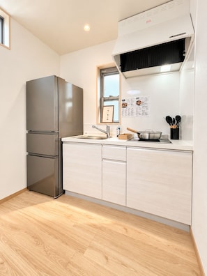 A modern kitchen with a stainless steel refrigerator, a window, and a sink. - A 6-minute walk from Shinjuku-Shin-Okubo Station! 4-Bedroom, 3-Story House for Exclusive Rental (Sleeps Up to 8) | 15-Minute Walk from Kabukicho (東京都新宿区大久保二丁目)