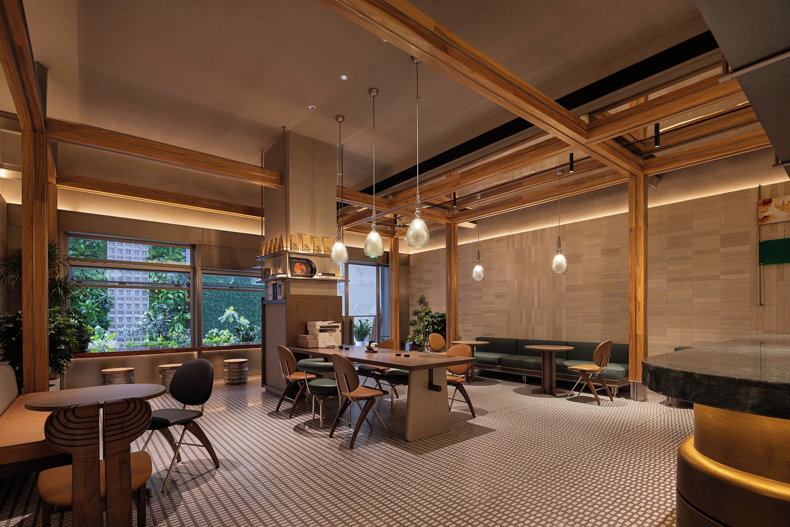 Un intérieur moderne avec un espace de repas central, de nombreux coins salon et de grandes fenêtres qui laissent entrer la lumière naturelle.