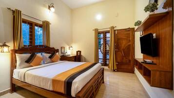 A bedroom with a wooden bed, bedside tables, a television, and a wardrobe.