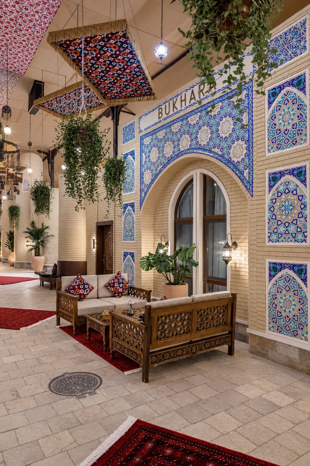 A lobby with a sofa, hanging plants, and patterned walls.
