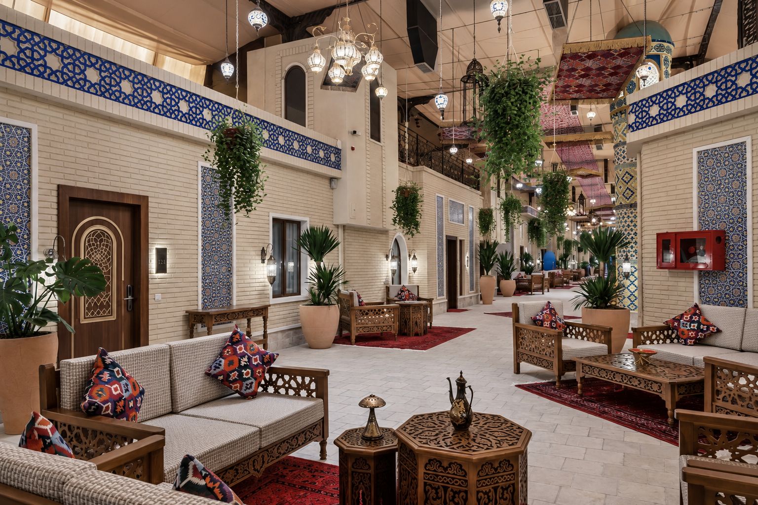 A spacious lobby with traditional decor, seating arrangements, and hanging plants.