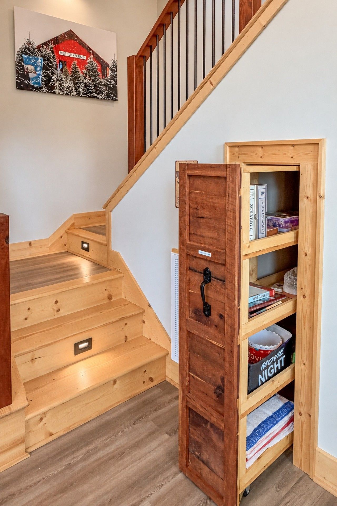 A wooden staircase with a built-in bookcase on the right side.