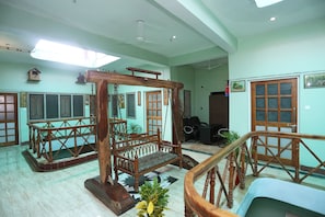 A room with a wooden swing set, a wooden staircase, and a view of the outside. - Collection-O Sara Grand Near Ram (Lucknow)