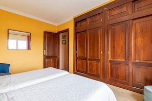 A bedroom with a bed, a wardrobe, and a window. - Vistabona, 5StarsHome Mallorca Villa (Capdepera)