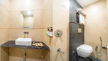 A bathroom with a sink, toilet, and shower.