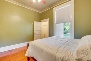 A bedroom with a bed, a window, and a door. - Classic Meridian Home Near Downtown Attractions (Meridian)