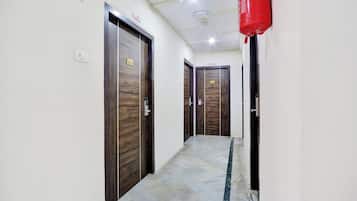 A hallway with wooden doors, numbered 101 and 103, and a 'No Smoking' sign.