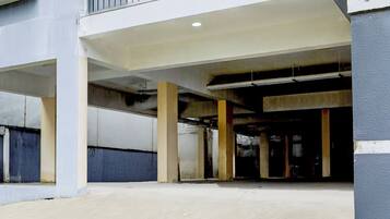 An underground parking garage with concrete pillars and a flat ceiling.