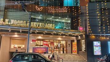 A hotel with a sign for 'The Maitis Hotels & Resorts' and a visible entrance.
