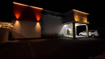 A building with a sign reading 'A35 Wisma Embun Raya' at night.
