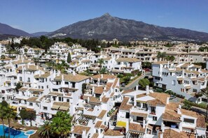 A coastal town with white buildings, a mountain in the background, and a swimming pool. - AB4 - Lovely holiday home walking distance, beach (Marbella)