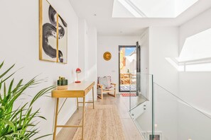 A modern interior with a desk, chair, and a view of the outdoors through a glass door. - Coral8 - Top modern townhouse in Estepona old town (Estepona)