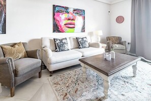 A living room with a sofa, armchairs, a coffee table, a rug, and a painting on the wall. - ELd41- Prime location, pool views and evening sun (Marbella)