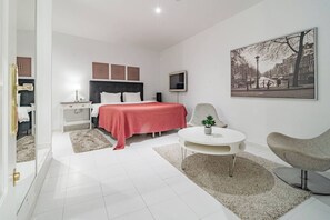 A modern bedroom with a bed, bedside table, chair, and a small table with a plant. - ELd41- Prime location, pool views and evening sun (Marbella)