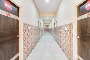 A hallway with doors labeled '1005' leading to rooms.