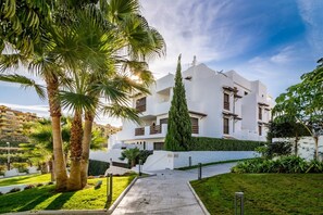 A modern building with a white facade, a central courtyard, and surrounding greenery. - GH-Modern 2 bed apartment with Pool in Estepona (Estepona)